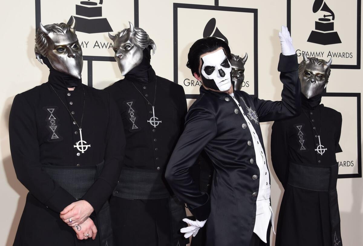 The members of Ghost arrive on the red carpet during the 58th Grammy Awards.