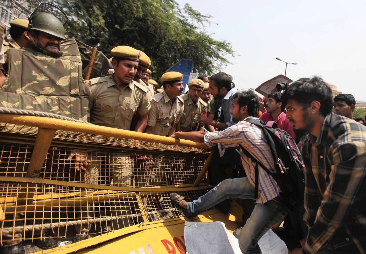 Protesters attempt to pull down a barricade outside police headquarters in New Delhi, where hundreds staged an angry demonstration after the kidnapping and rape of a 5-year-old girl.