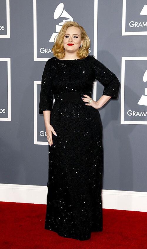 Adele, dressed in a custom Giorgio Armani gown, is a multiple-award nominee, including song, album and artist.