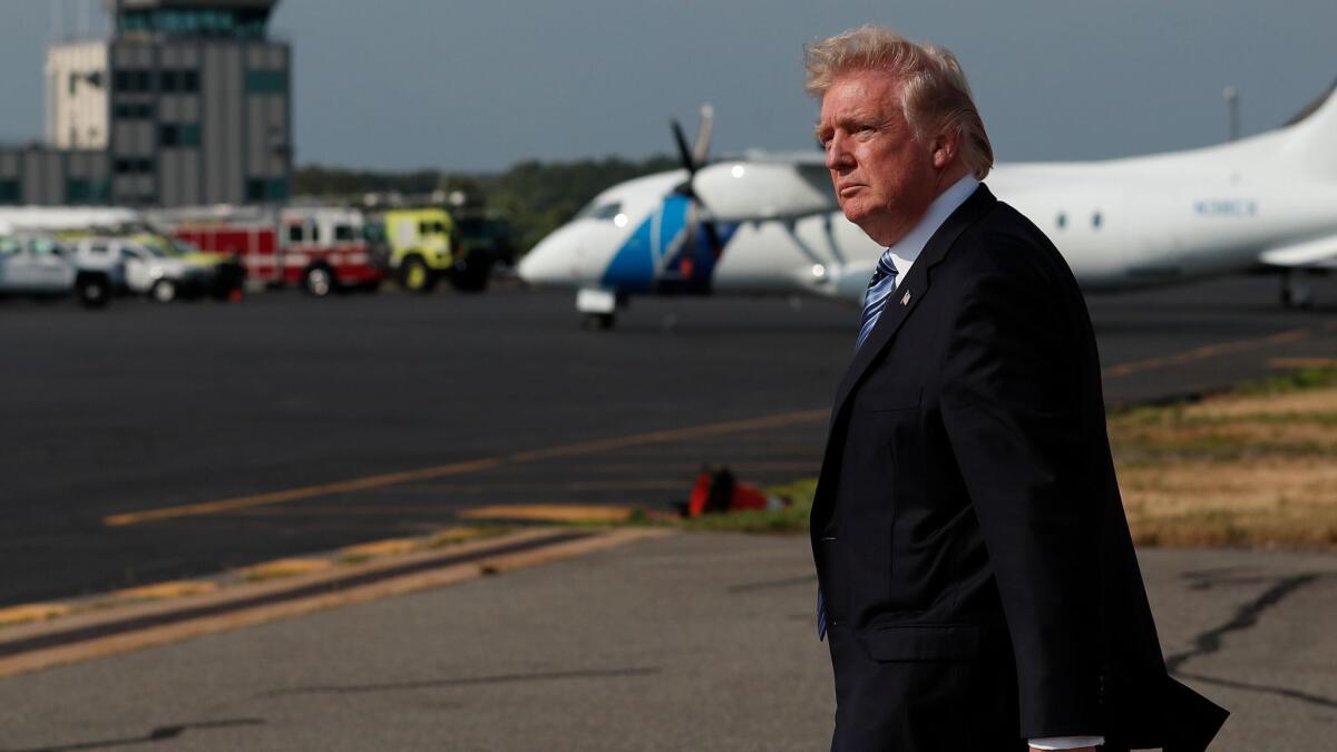 President Trump walk across the tarmac to Marine One at Morristown Municipal Airport, in Morristown, N.J., on June 30.