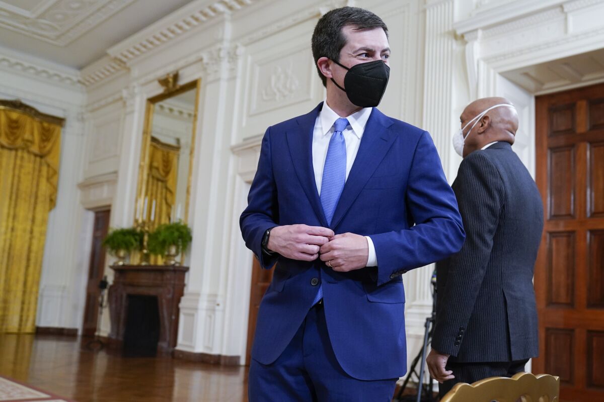 Transportation Secretary Pete Buttigieg arrives to attend an event on the global supply chain bottlenecks during in the East Room of the White House, Wednesday, Oct. 13, 2021, in Washington. (AP Photo/Evan Vucci)
