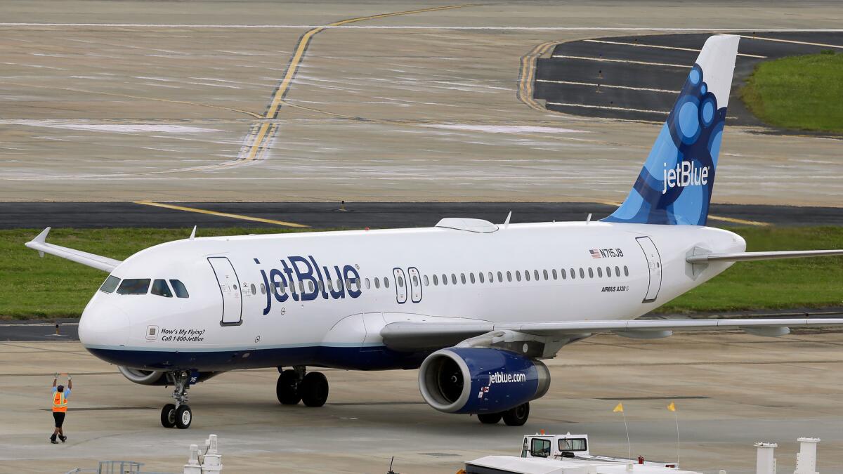 A JetBlue Airways Airbus A320-232 pushes back from the gate at Tampa International Airport.