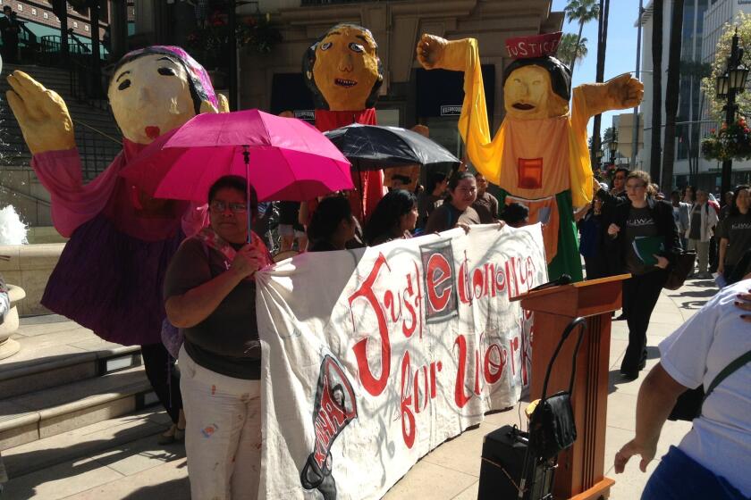 Protesters converge outside Urasawa on Rodeo Drive after the famed sushi restaurant was cited over labor violations.