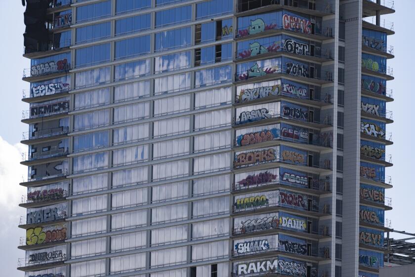 An unfinished high-rise development in the downtown entertainment district that has become the target of graffiti taggers who have struck dozens of floors is seen in Los Angeles on Friday, Feb. 2, 2024. (AP Photo/Damian Dovarganes)