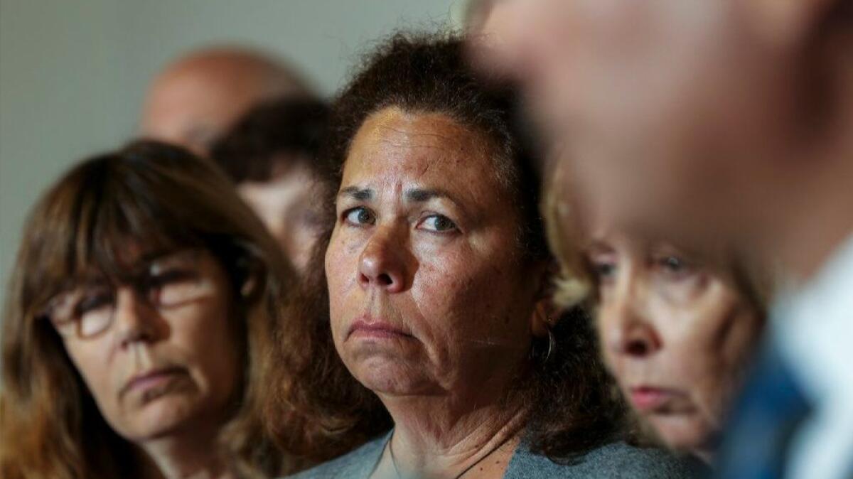 Sheryl Tidus, center, flanked by other family members, appears at a news conference to promote a reward in the killing of her husband, Jeffrey Tidus, in 2009.