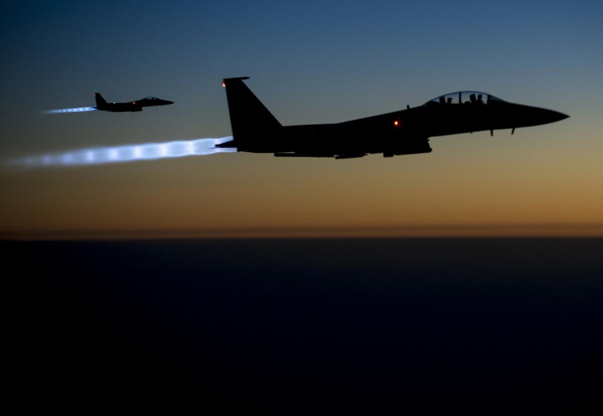 A pair of U.S. F-15E Strike Eagle fly over northern Iraq, after conducting airstrikes in Syria.