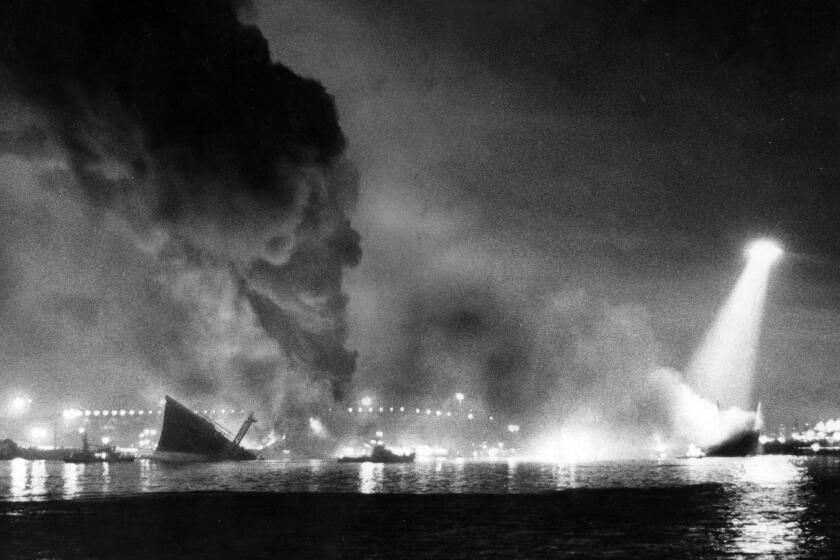 Dec. 17, 1976: Split in two, the 810-foot Liberian oil tanker Sansinena lies burning at San Pedro in Los Angeles Harbor after an explosion aboard rocked the coast, shattering windows in Costa Mesa, 20 miles away. This photo appeared in the Dec. 18, 1982, Los Angeles Times.