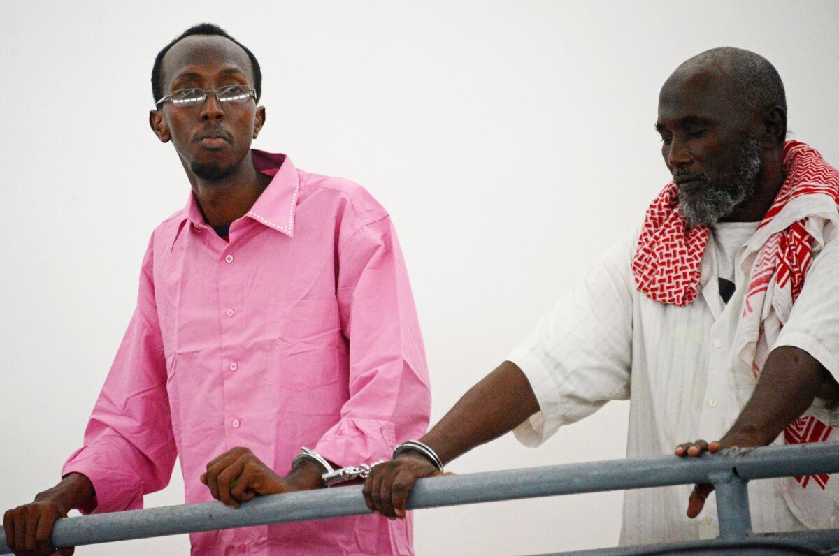 Somali journalist Abdiaziz Abdinur Ibrahim, left, in court in Mogadishu.
