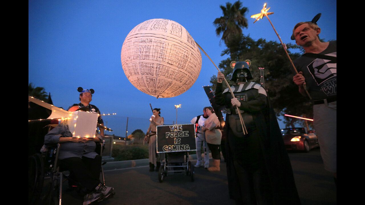 Debbie Marlis holds a glowing Death Star during the Anaheim Halloween Parade on Saturday.