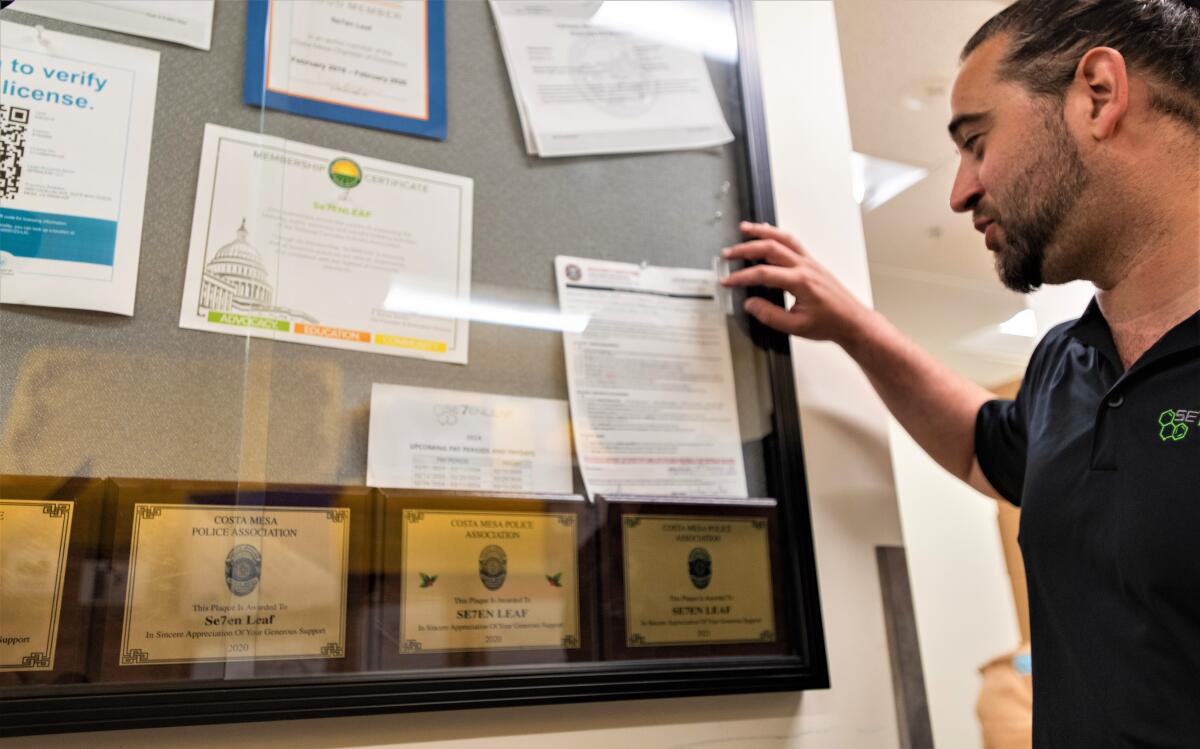 A display case at a Se7enleaf facility in Costa Mesa shows off awards given by the city's police association over the years. 
