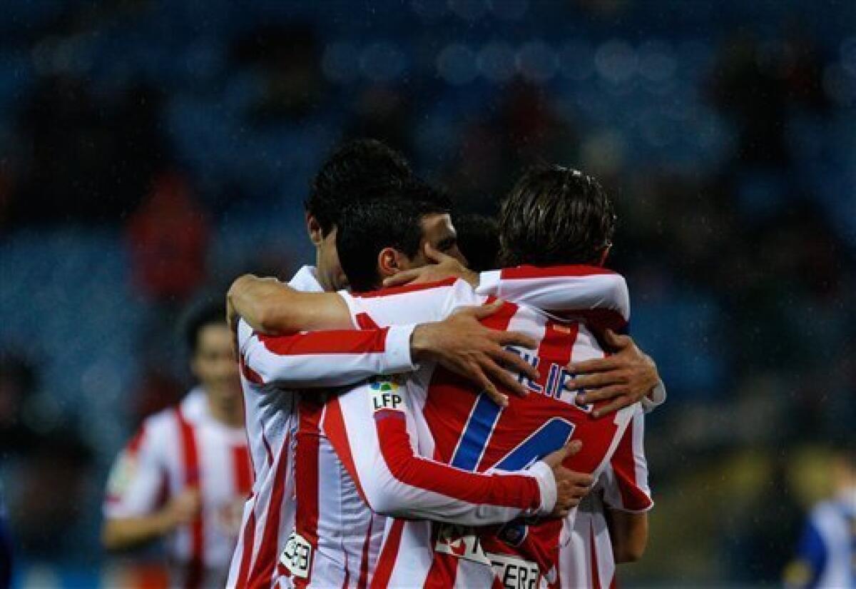 Atletico de Madrid's Simao Sabrosa from Portugal, center, reacts after scoring a penalty against Espanyol with fellow team members during their Spanish Copa del Rey soccer match at the Vicente Calderon stadium in Madrid, Wednesday, Dec. 22, 2010. (AP Photo/Arturo Rodriguez)