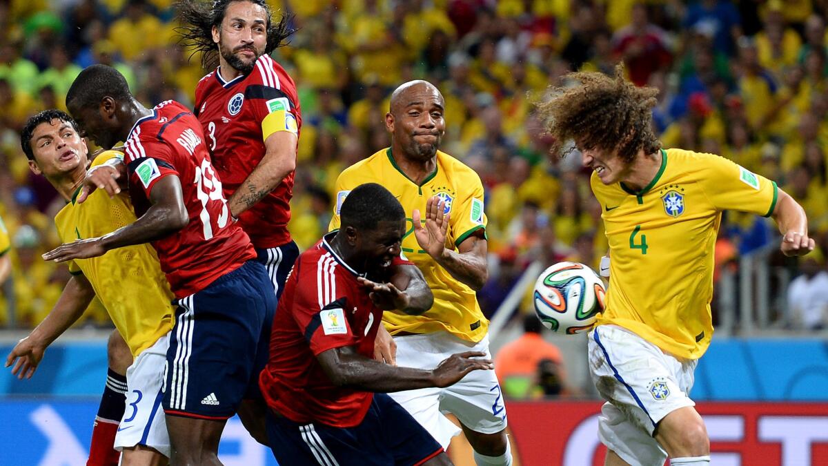 Colombian and Brazilian players battle for the ball during Brazil's World Cup quarterfinal victory Friday. Brazil has committed a tournament-leading 96 fouls heading into Tuesday's semifinal match with Germany.