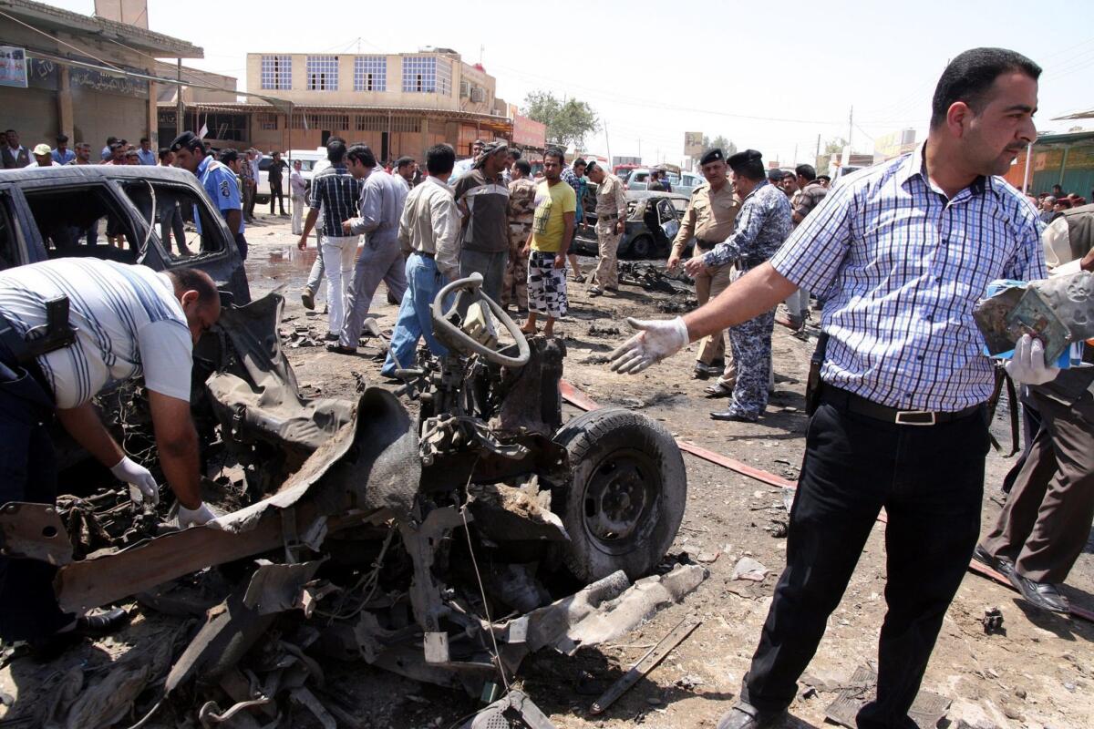 Police officers inspect the site of a bomb attack in the southern Iraqi city of Karbala.
