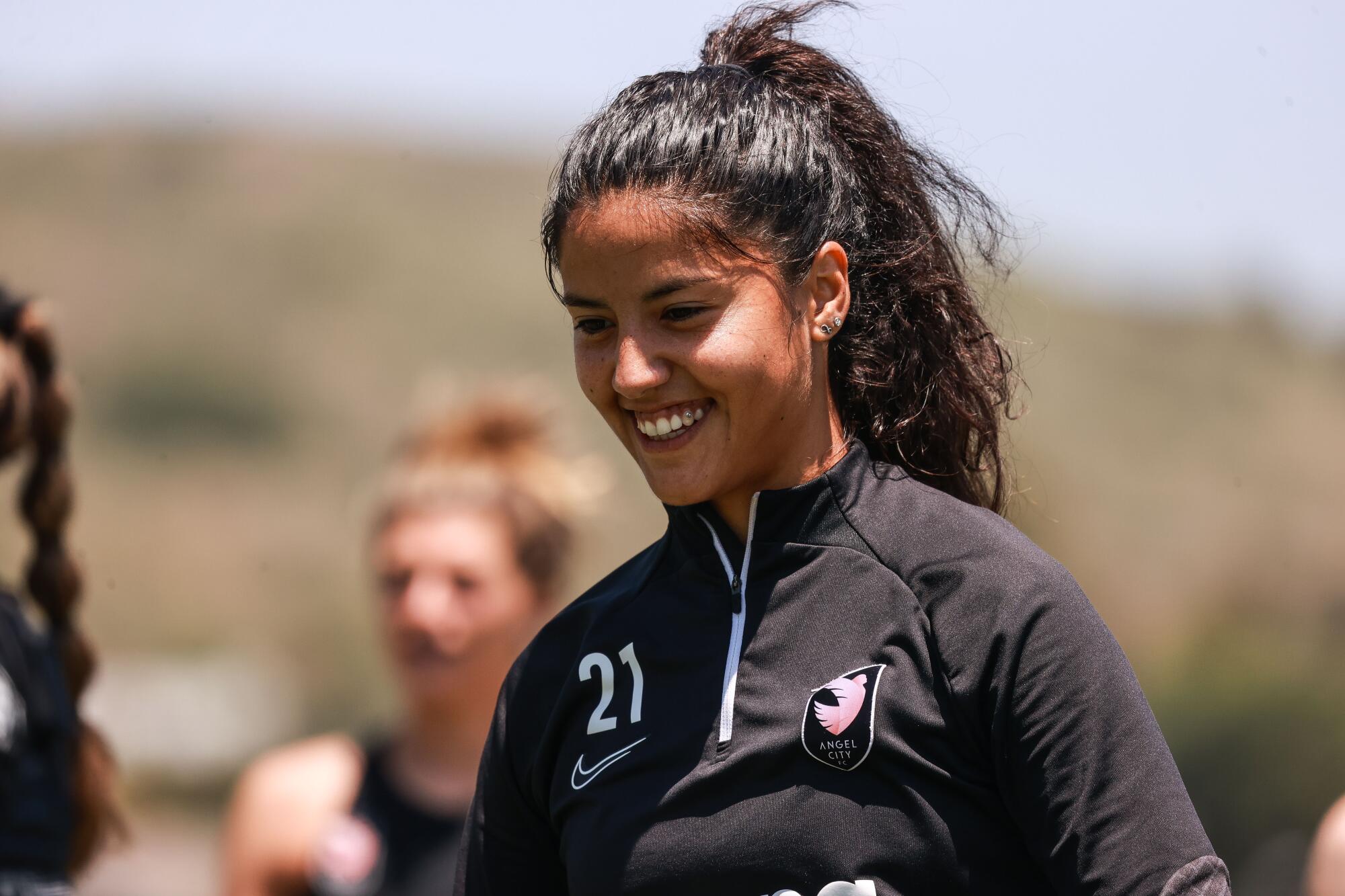 Angel City FC's Stefany Ferrar Van Ginkel smiles during a team practice session.