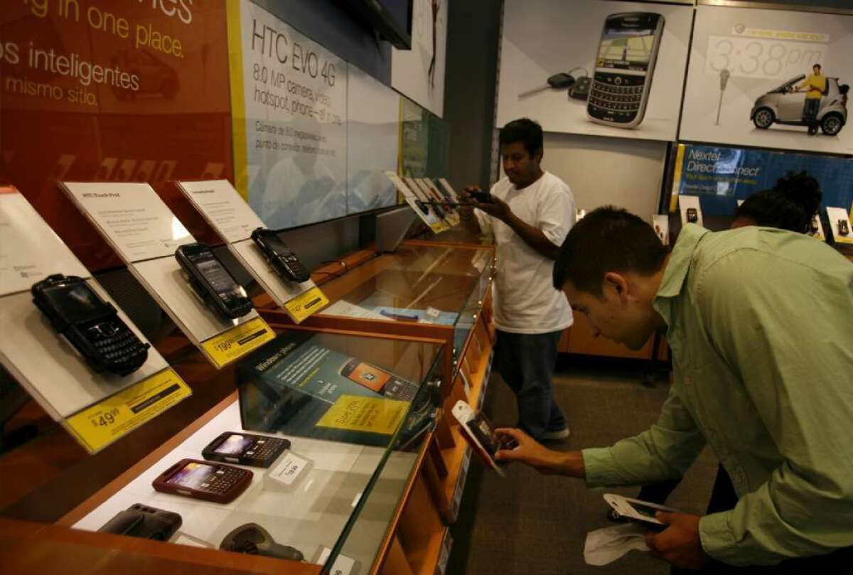 Customers shop for phones at a Sprint Corp. store in Silver Lake.
