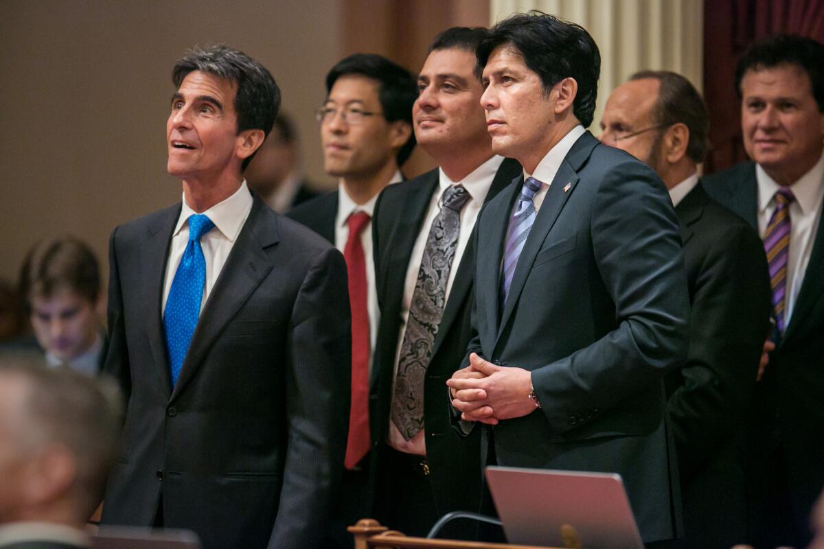 Senate leader Kevin de León (D-Los Angeles), with folded hands, watches as votes are cast on SB 350, a bill to fight climate change. The legislation was signed by Gov. Jerry Brown on Wednesday in Los Angeles.
