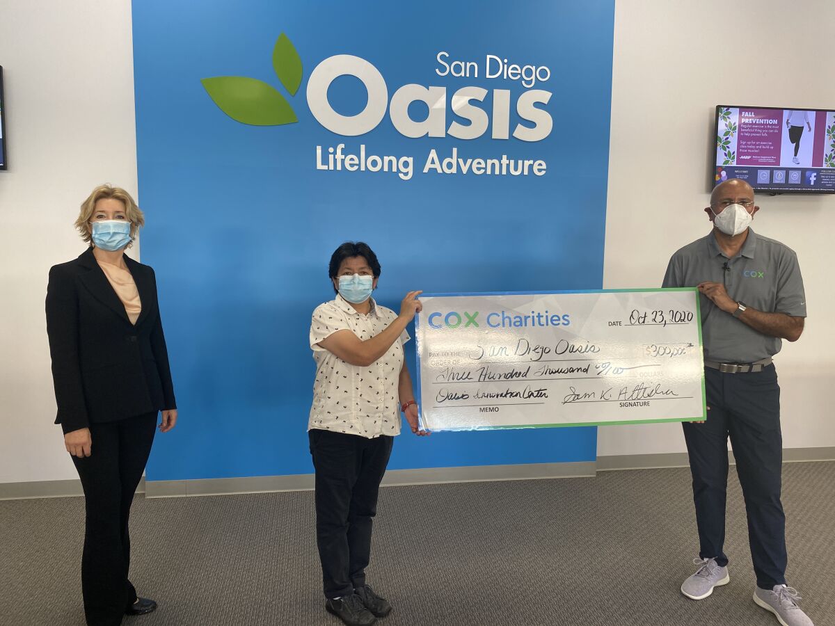Cox Communications' Sam Attisha delivers $300,000 check to San Diego Oasis CEO and president Simona Valanciute
