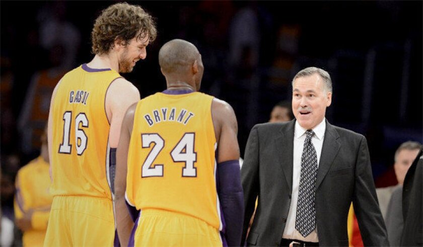 New Lakers Head Coach Mike D'Antoni welcomes Pau Gasol and Kobe Bryant as they leave the court following the Lakers' win over the Nets, 95-90.