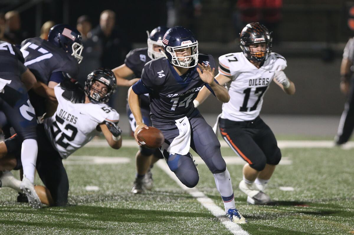 Newport Harbor quarterback Cole Lavin, seen running against Huntington Beach on Sept. 28, 2018, scored the go-ahead touchdown in the Sailors' 24-14 win at Aliso Niguel on Friday.