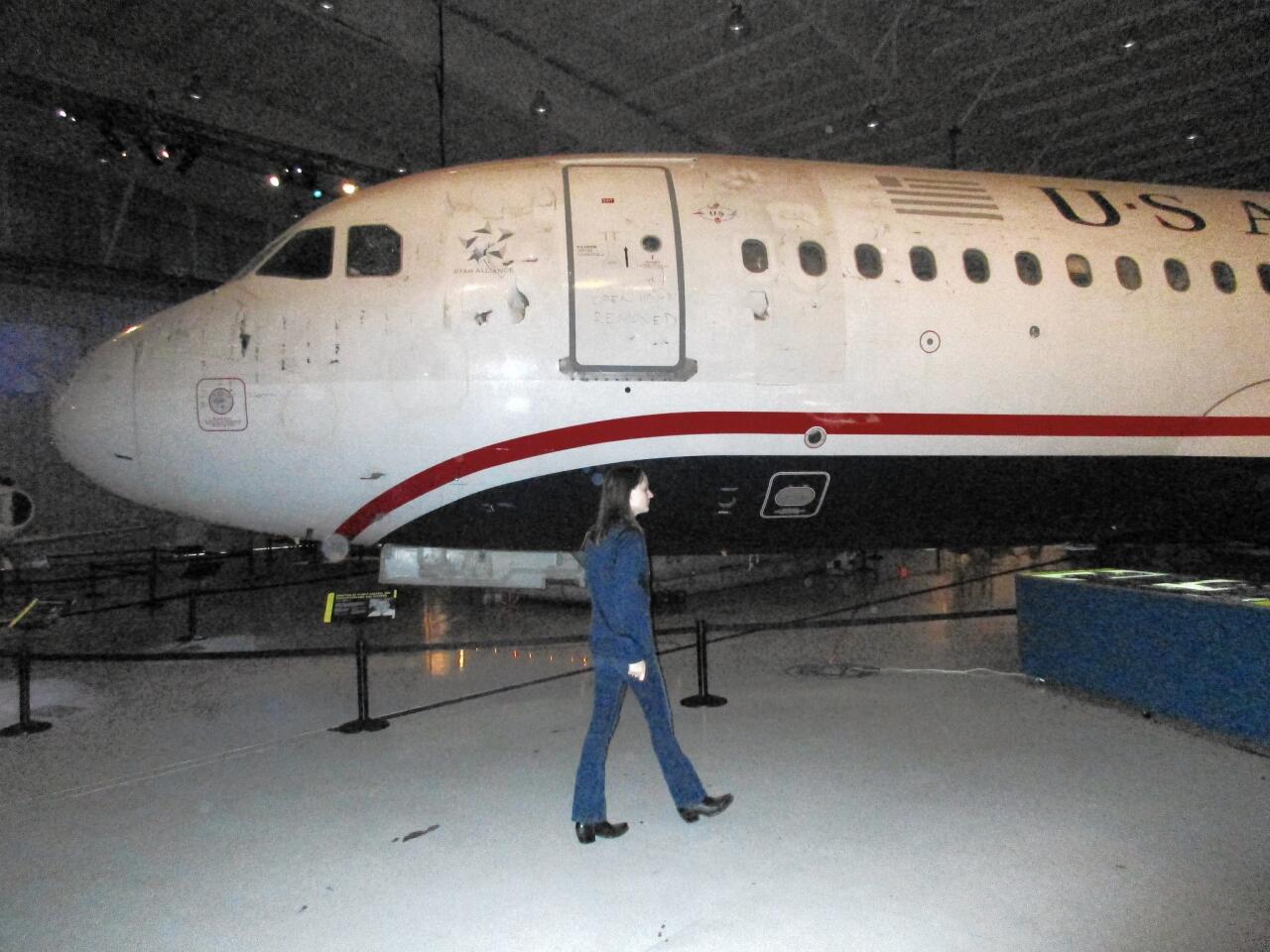The roped-off Airbus A320 sits low to the ground so that the jet's tall tail can fit inside the museum's dimly lit hangar.