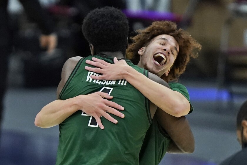 Ohio's Jason Preston, right, celebrates with Dwight Wilson III after they defeated Buffalo in an NCAA college basketball game in the championship of the Mid-American Conference tournament, Saturday, March 13, 2021, in Cleveland. (AP Photo/Tony Dejak)