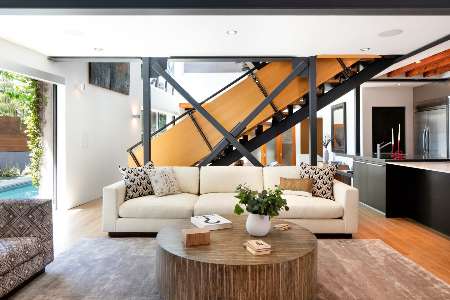 A sculptural staircase divides the living space on the main floor.