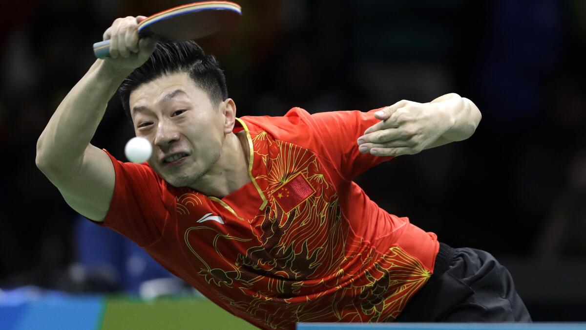 China's Ma Long returns a shot against countryman Zhang Jike during the gold-medal match on Thursday.