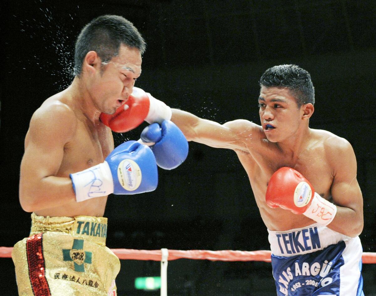 Nicaraguan champion Roman Gonzalez, right, sends his right to Japanese challenger Katsunari Takayama in the third round of their 12-round scheduled WBA minimumweight title bout in Kobe, western Japan, Tuesday, July 14, 2009. Gonzalez retained his title with a unanimous decision. (AP Photo/Kyodo News) ** JAPAN OUT MANDATORY CREDIT FOR COMMERCIAL USE ONLY IN NORTH AMERICA **