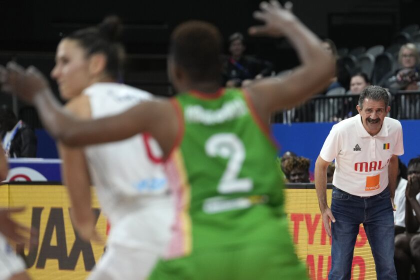 Mali's head coach Joaquin Brizuela Carrion watch's their game against Serbia during their game at the women's Basketball World Cup in Sydney, Australia, Monday, Sept. 26, 2022. (AP Photo/Rick Rycroft)