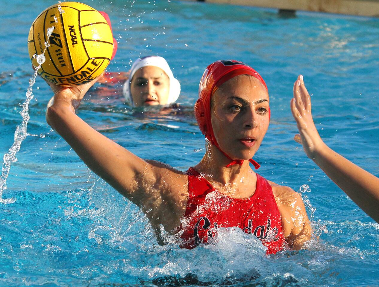 Glendale's Naira Sarkian shoots and scores against Hoover in a Pacific League girls water polo match at Glendale High School on Thursday, January 16, 2014. (Tim Berger/Staff Photographer)