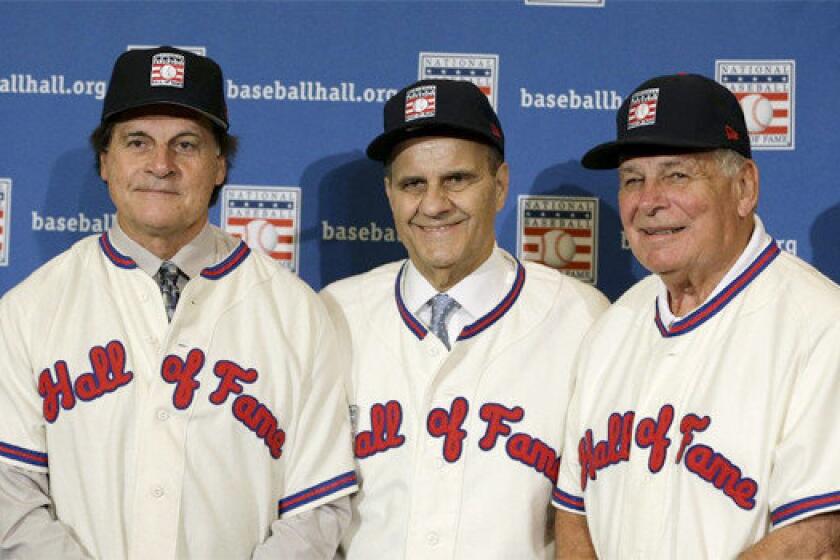 Tony La Russa, Joe Torre and Bobby Cox gather for a photo after they were unanimously elected to the baseball Hall of Fame on Monday.