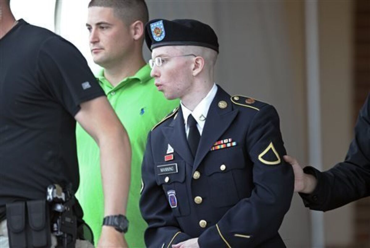 Army Pfc. Bradley Manning is escorted out of a courthouse at Fort Meade, Md., on the fourth day of his court martial, Monday, June 10, 2013. Manning is charged with indirectly aiding the enemy by sending troves of classified material to WIkiLeaks. He faces up to life in prison. (AP Photo/Cliff Owen)