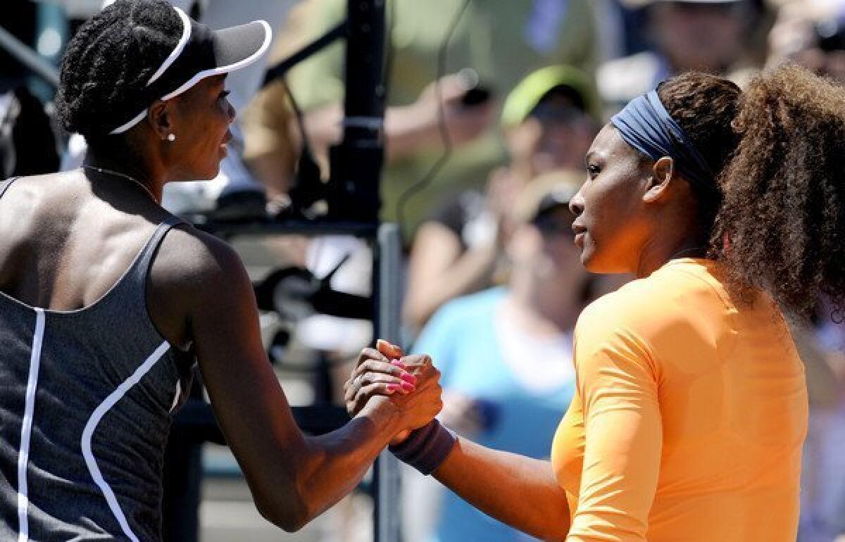 Serena Williams, right, shakes hands with her sister Venus Williams after her 6-1, 6-2 victory on Saturday in the semifinals of the Family Circle Cup tennis tournament in Charleston, S.C.