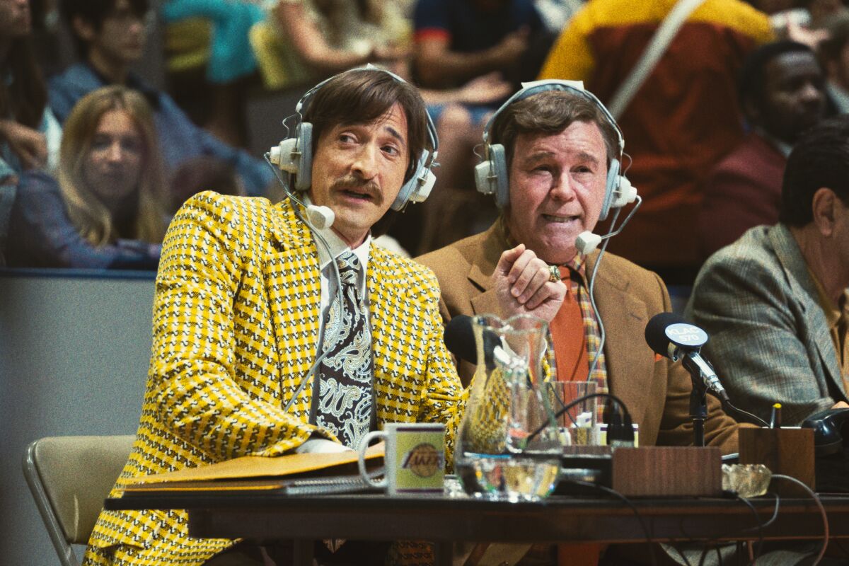 Two basketball play-by-play announcers in garish 1970s suits.