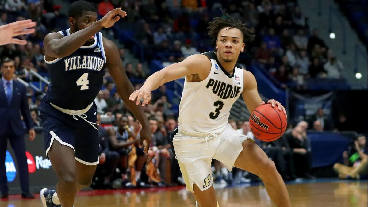 Purdue's Carsen Edwards (3) is defended by Villanova's Eric Paschall (4) in the second half during the second round of the NCAA tournament on Saturday in Hartford, Conn.