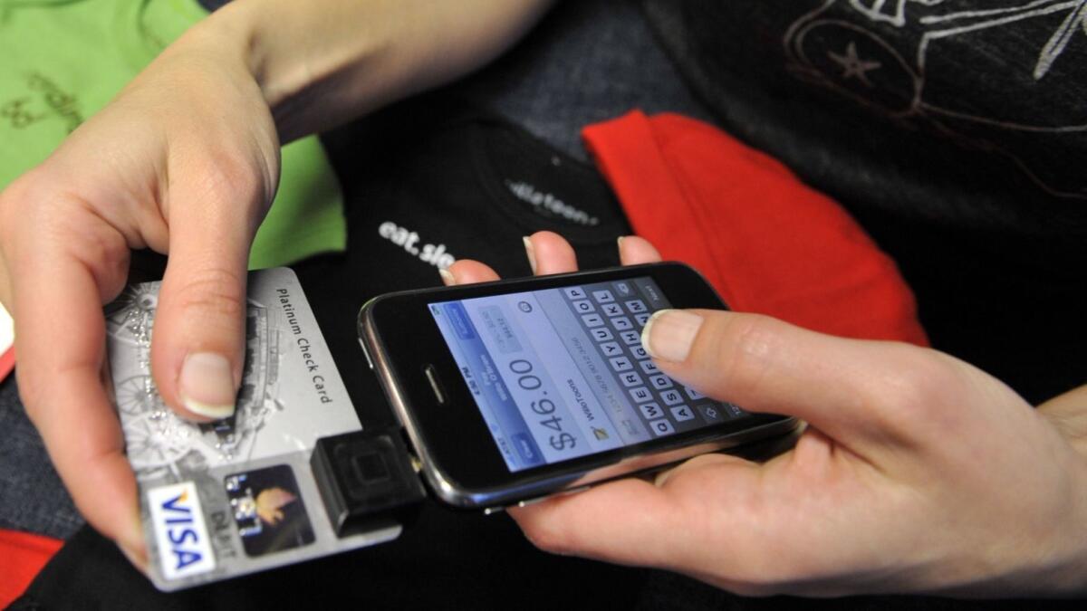 A person demonstrates the Square payment system on her iPhone in 2009.