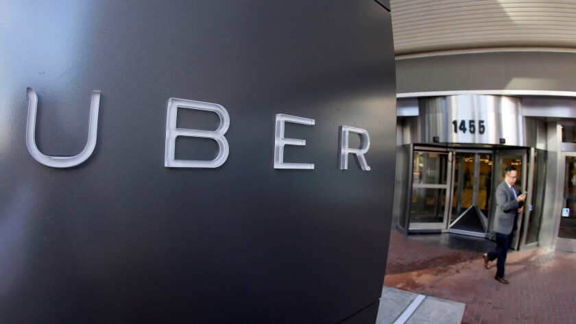 A man leaves the headquarters of Uber in San Francisco in 2014.