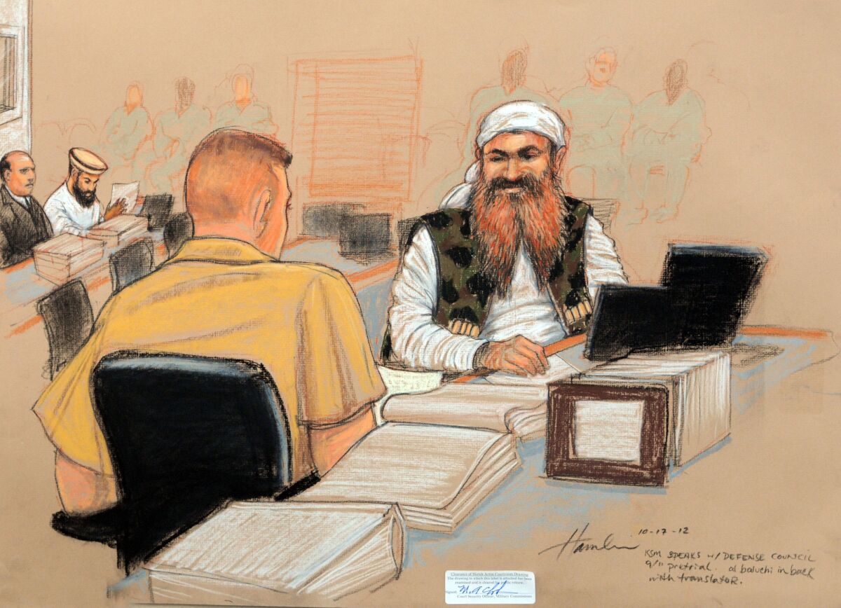 A courtroom sketch shows alleged Sept. 11 mastermind Khalid Shaikh Mohammed, right, speaking with a member of his legal team during a pretrial hearing at the U.S. military base at Guantanamo Bay, Cuba.