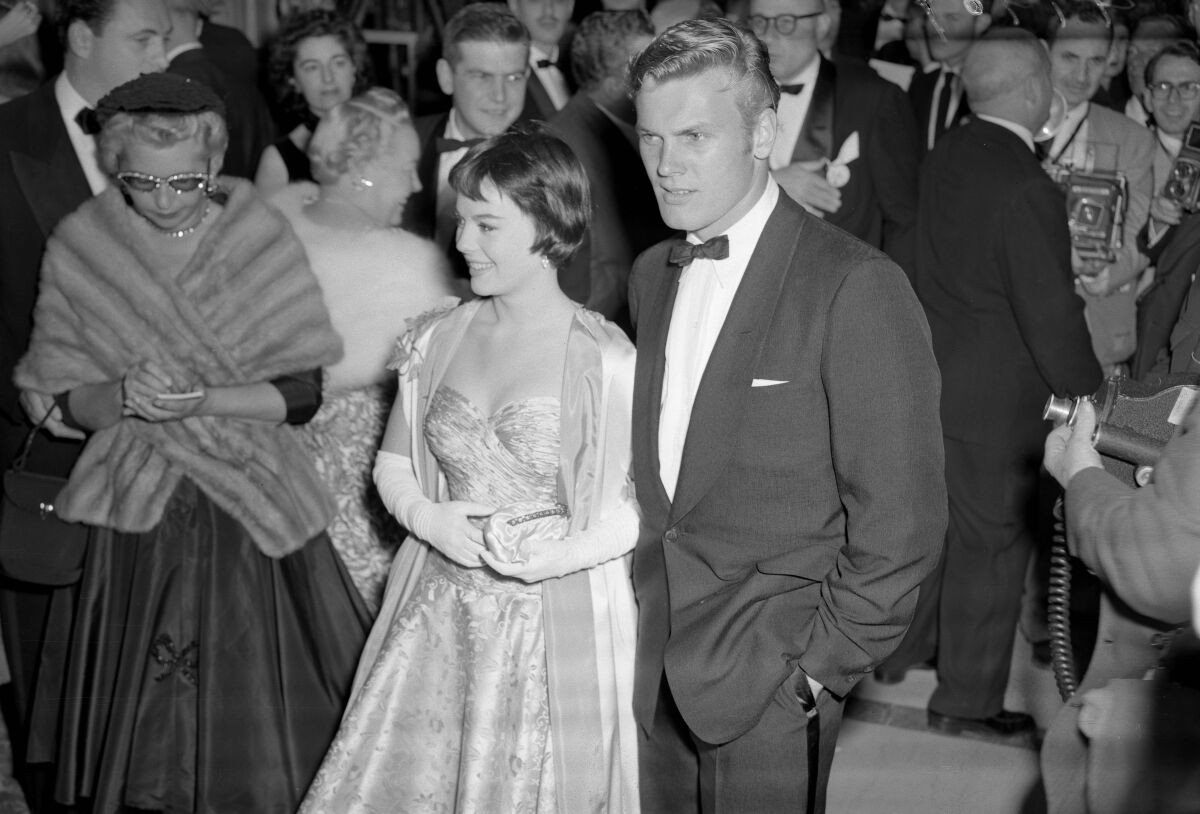 Natalie Wood in a formal gown and elbow-length gloves,Tab Hunter in a tux