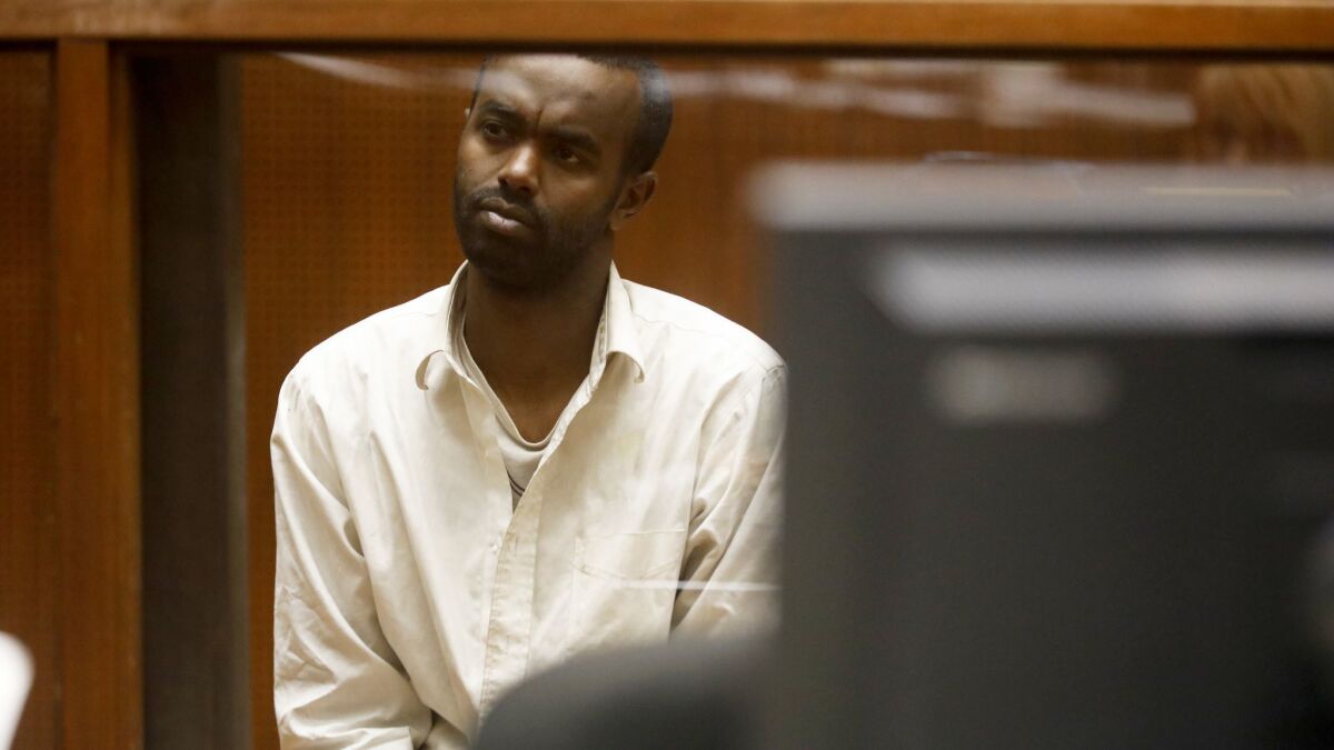 Mohamed Abdi Mohamed appears in a downtown L.A. courthouse. He is accused of trying to run over two men near a Los Angeles synagogue and has been charged with two counts of assault with a deadly weapon.