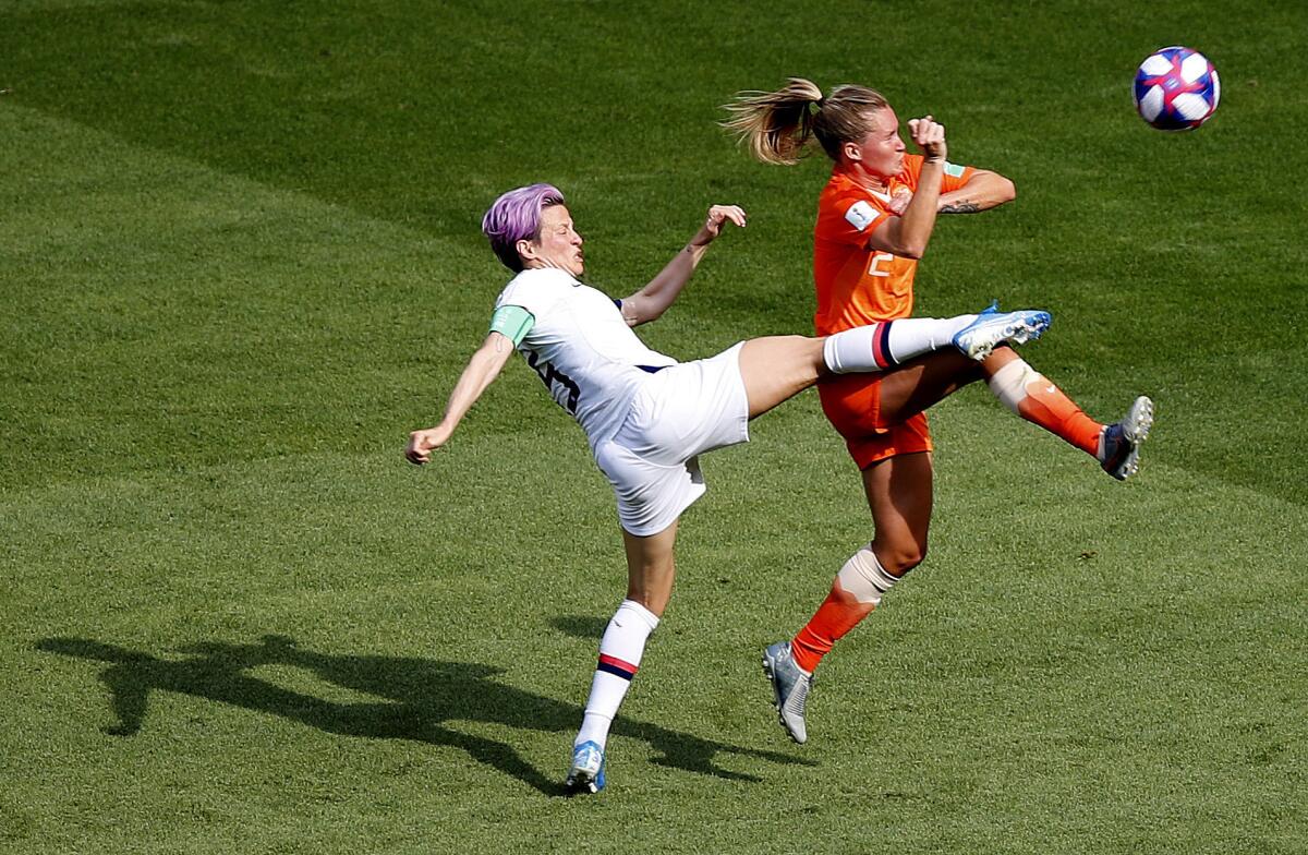 U.S. forward Megan Rapinoe, left, and Netherlands midfielder Desiree Van Lunteren challenge for the ball during the FIFA Women's World Cup final in Lyon, France, on Sunday.