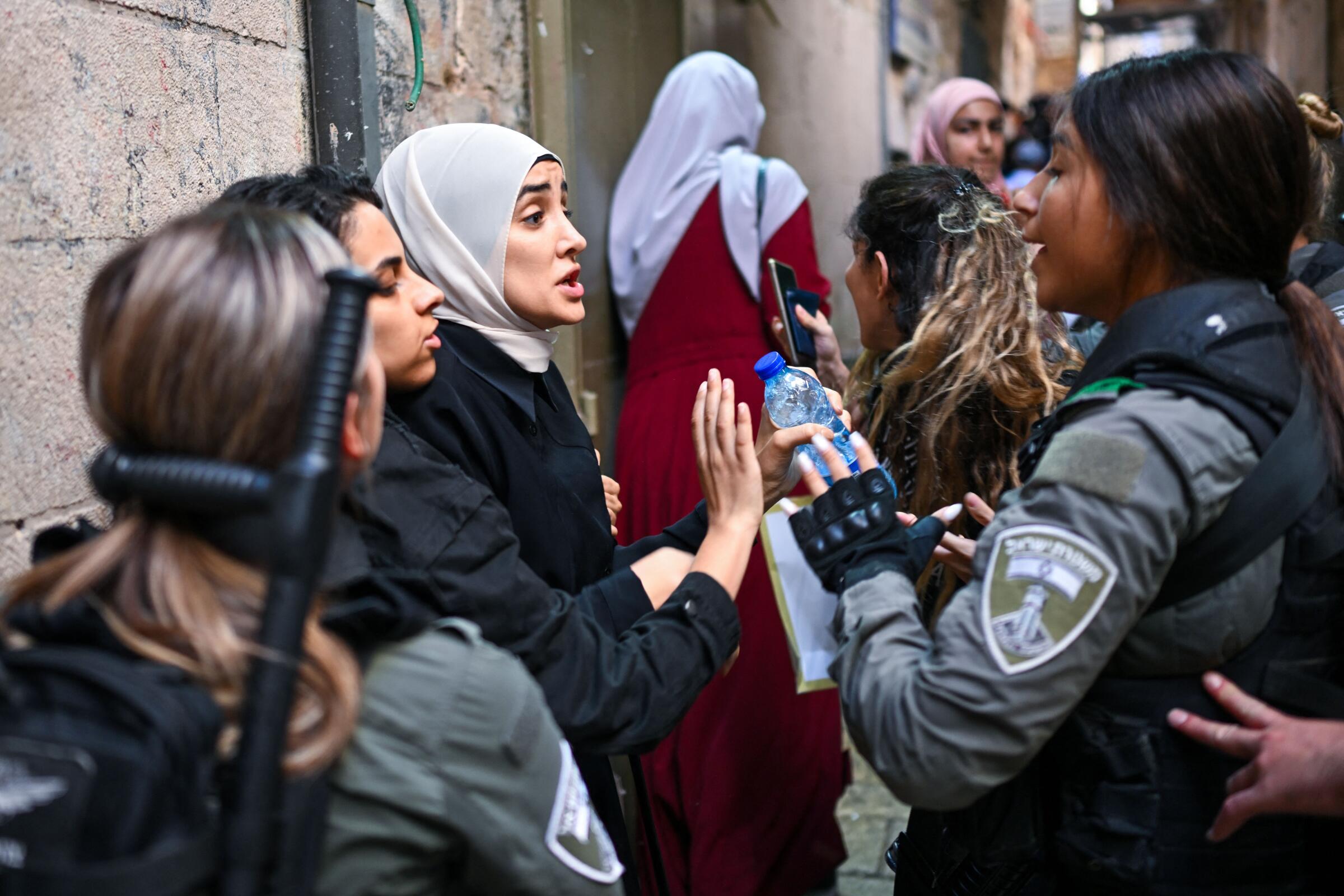 Muslim women speak to Israeli soldiers in Jerusalem's Old City.