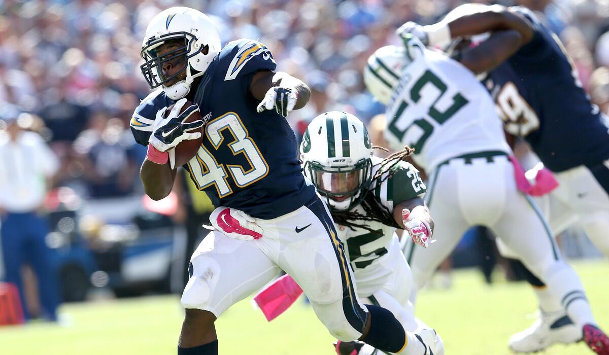 Chargers running back Branden Oliver gets past Jets safety Calvin Pryor on a 15-yard touchdown run Sunday in San Diego.