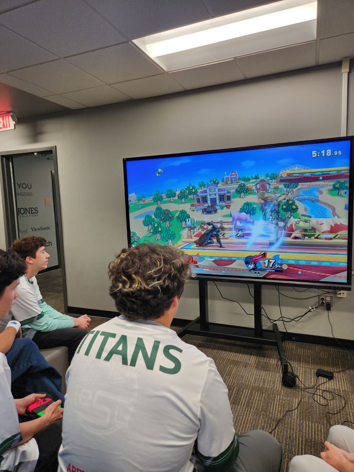 Martin Murguia (center) playing Super Smash Bros. Ultimate on the Nintendo Switch at the new Esports Arena at Poway High.