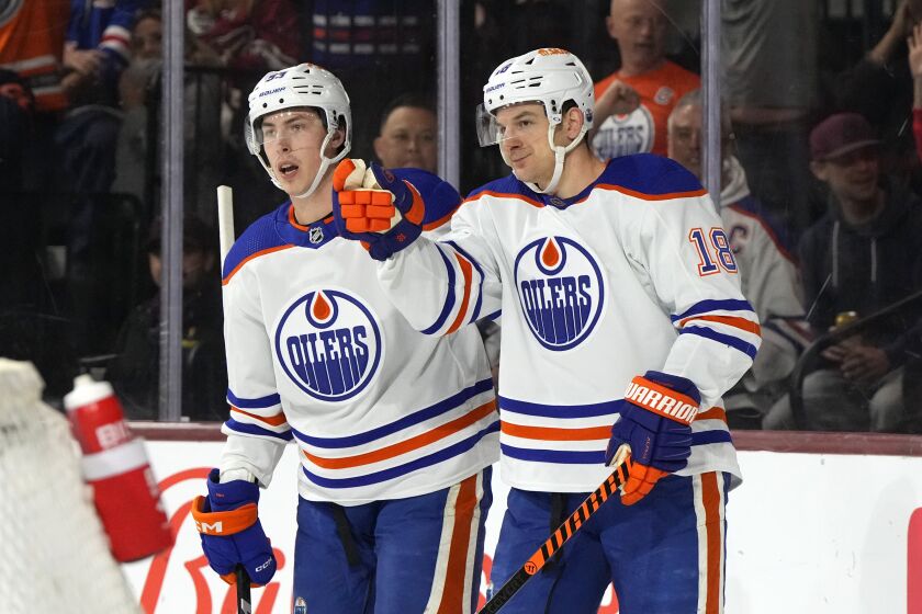 Edmonton Oilers left wing Zach Hyman (18) celebrates with center Ryan Nugent-Hopkins after scoring a goal aginst the Arizona Coyotes in the first period during an NHL hockey game, Monday, March 27, 2023, in Tempe, Ariz. (AP Photo/Rick Scuteri)