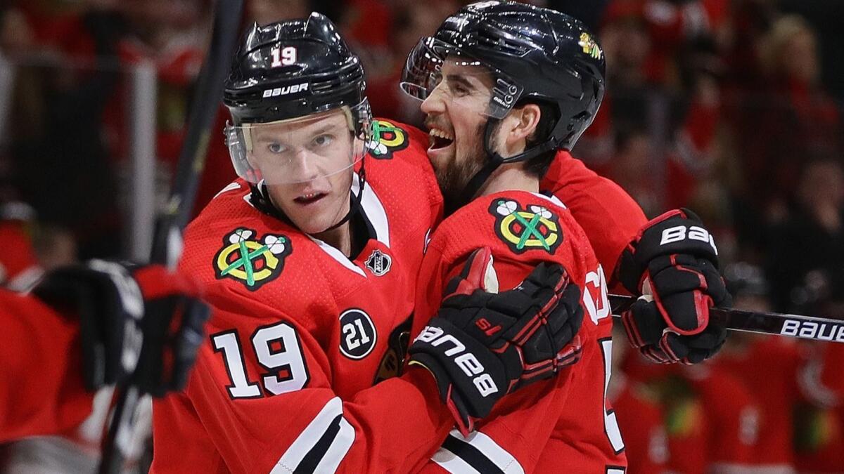 Chicago Blackhawks' Jonathan Toews, left, and Erik Gustafsson celebrate Toews' power play goal in the third period against the Dallas Stars on Sunday. The Stars defeated the Blackhawks 4-3.