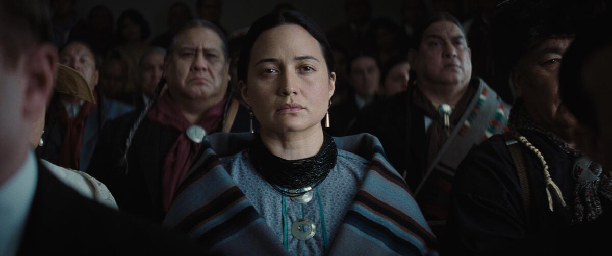A Native American woman looks on from the gallery of a courtroom in a scene from "Killers of the Flower Moon."
