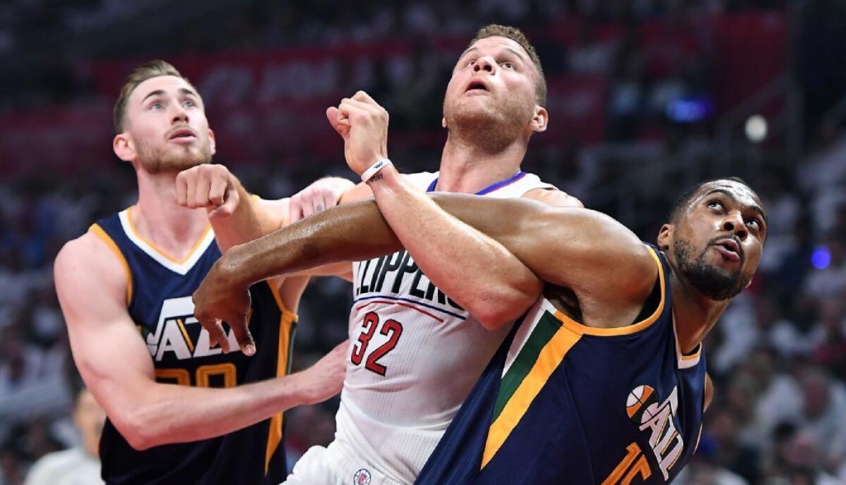 Clippers forward Blake Griffin battles Jazz players Gordon Hayward, left, and Derrick Favors during the first quarter of Game 2 at Staples Center on April 18.