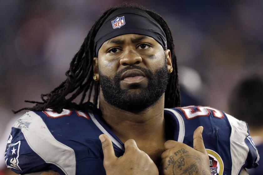 New England Patriots' Brandon Spikes watches from the bench in December 2012.