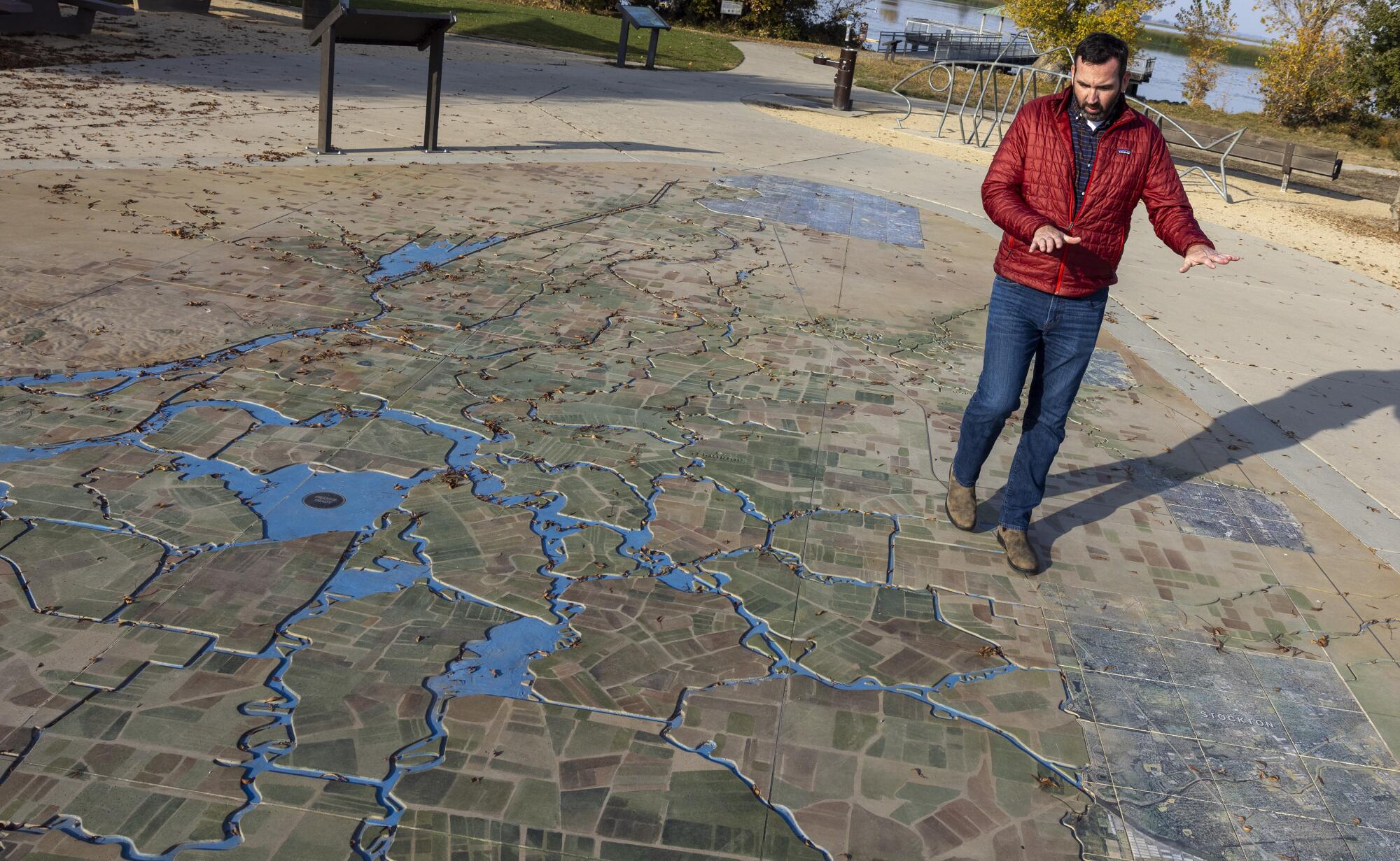 A man stands atop an interactive map of the delta.  